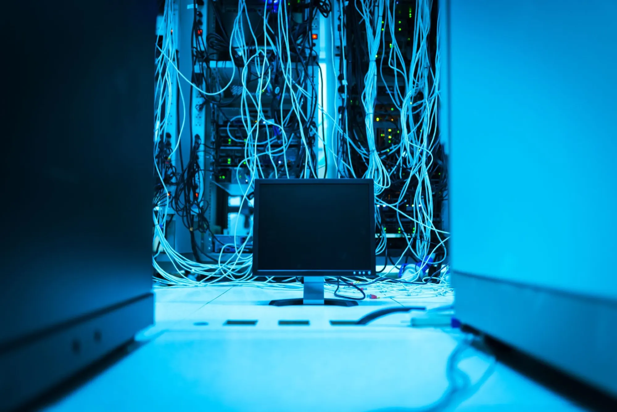 Data centre server room lit in blue, representing data protection