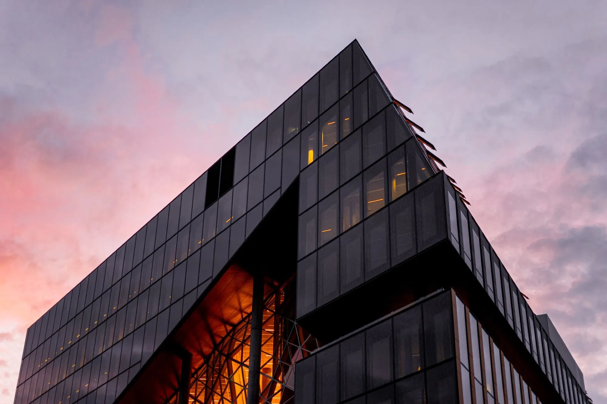 Modern glass office tower at dusk