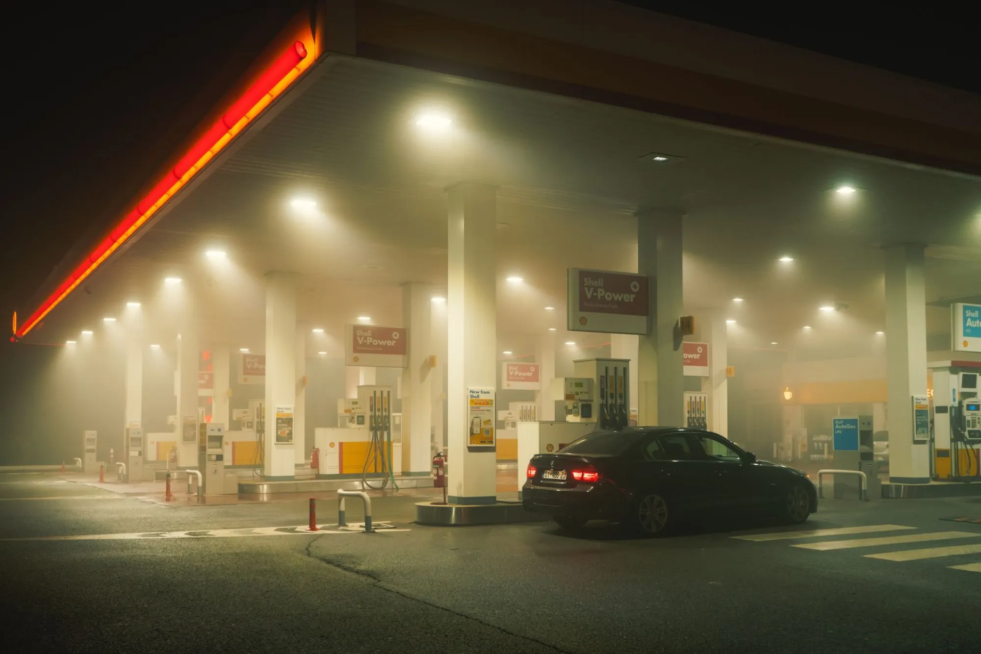 Petrol station forecourt lit at night